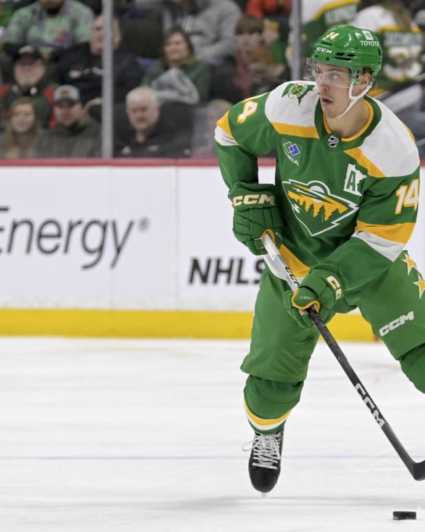 Feb 17, 2024; Saint Paul, Minnesota, USA; Minnesota Wild forward Joel Eriksson Ek (14) skates with the puck against the Buffalo Sabres during the second period at Xcel Energy Center.